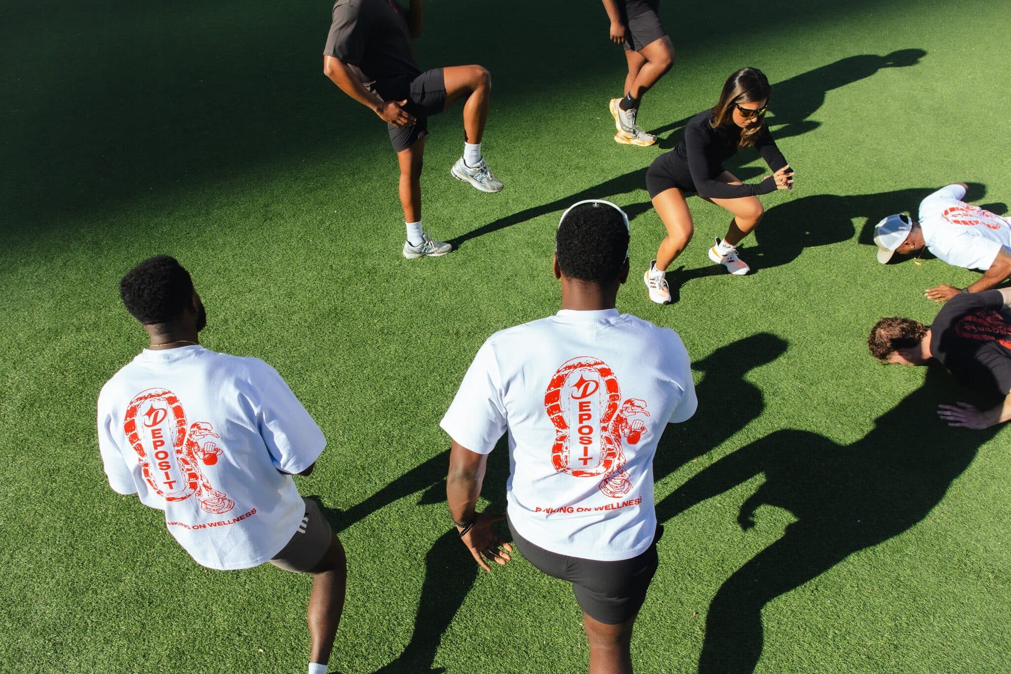 Overhead group stretch on turf.